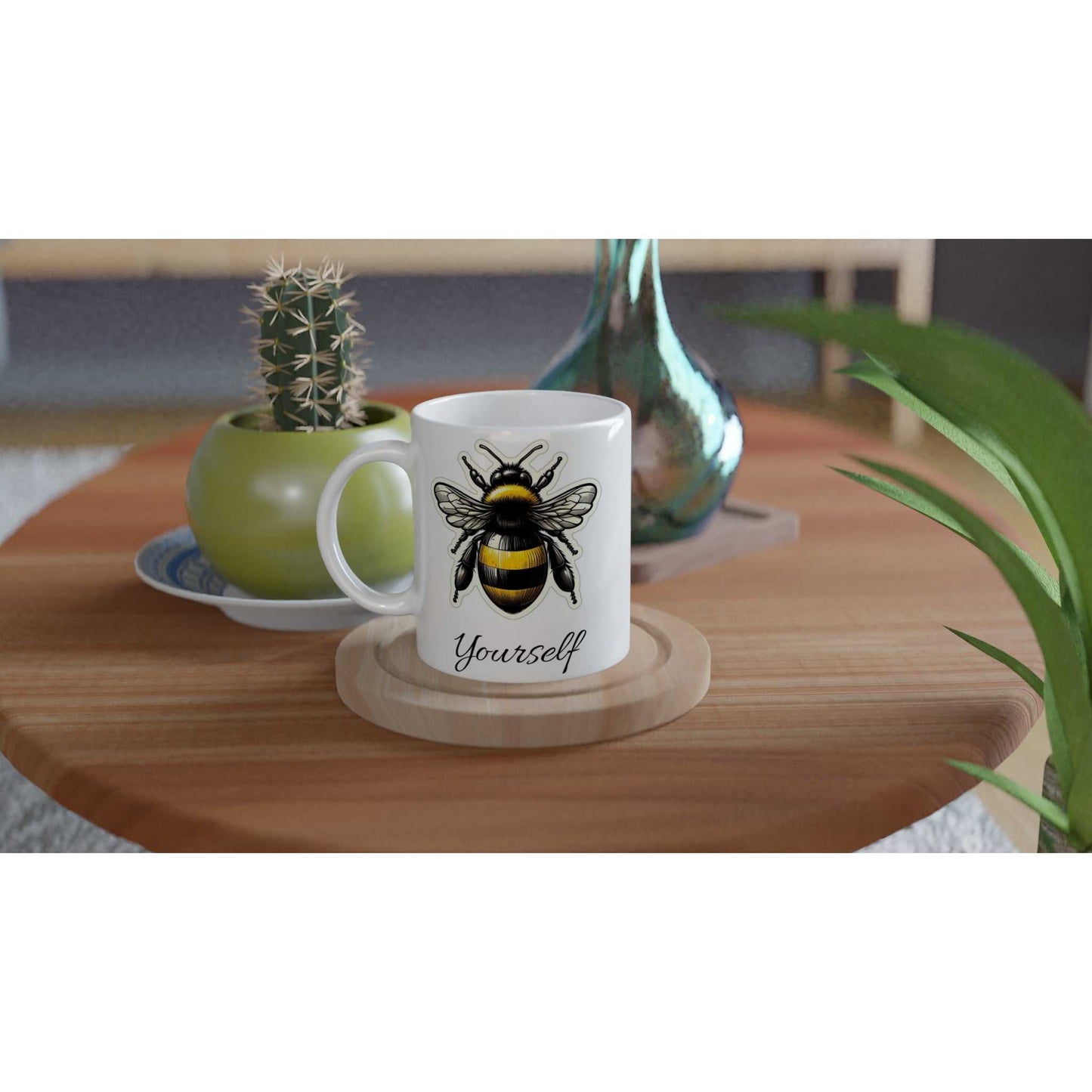 White 11oz ceramic mug with bee design on table.