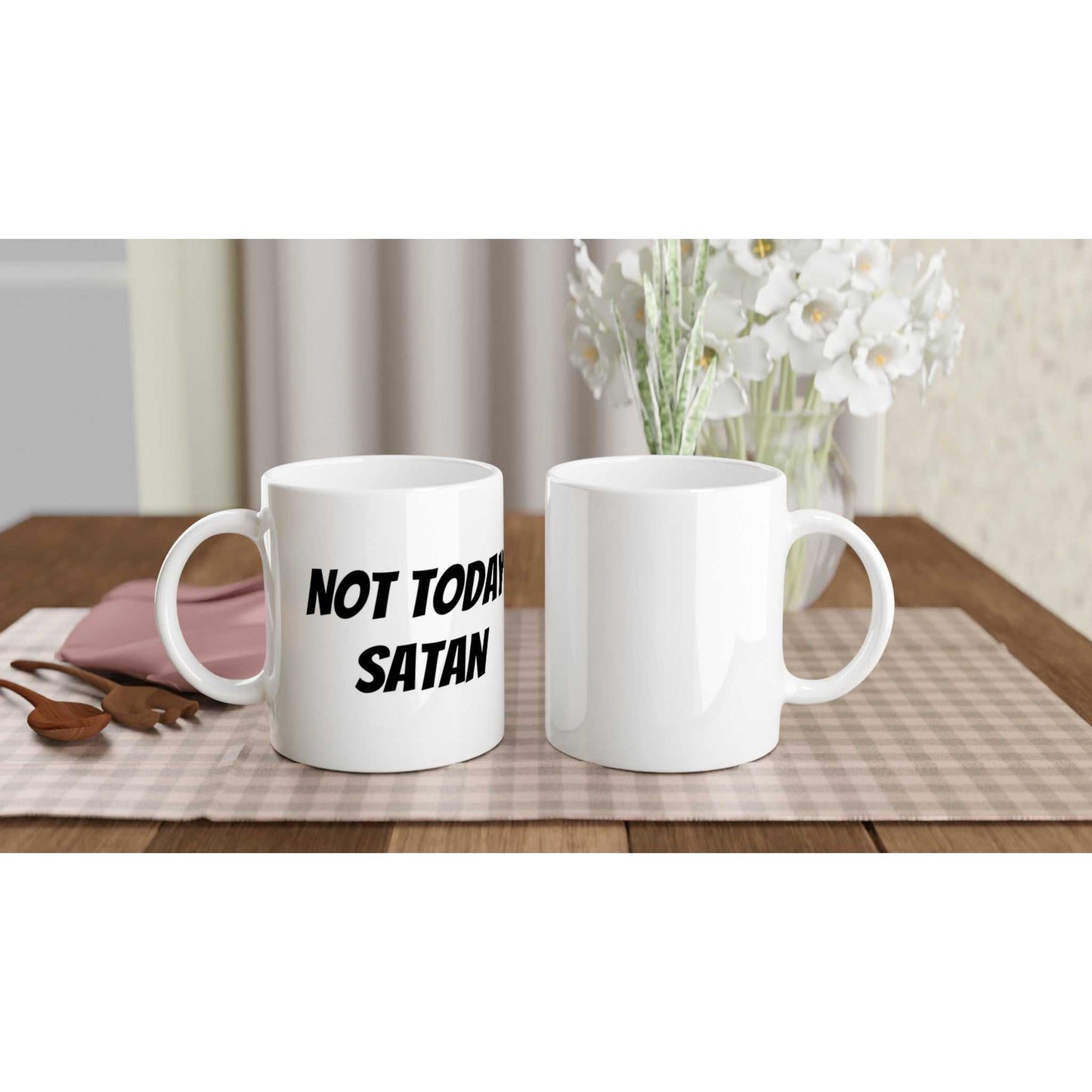 Not Today Satan White 11oz Ceramic Mug on table, microwave and dishwasher safe.