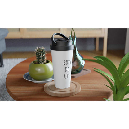 Boys Do Cry White 15oz Stainless Steel Travel Mug on table with plants.