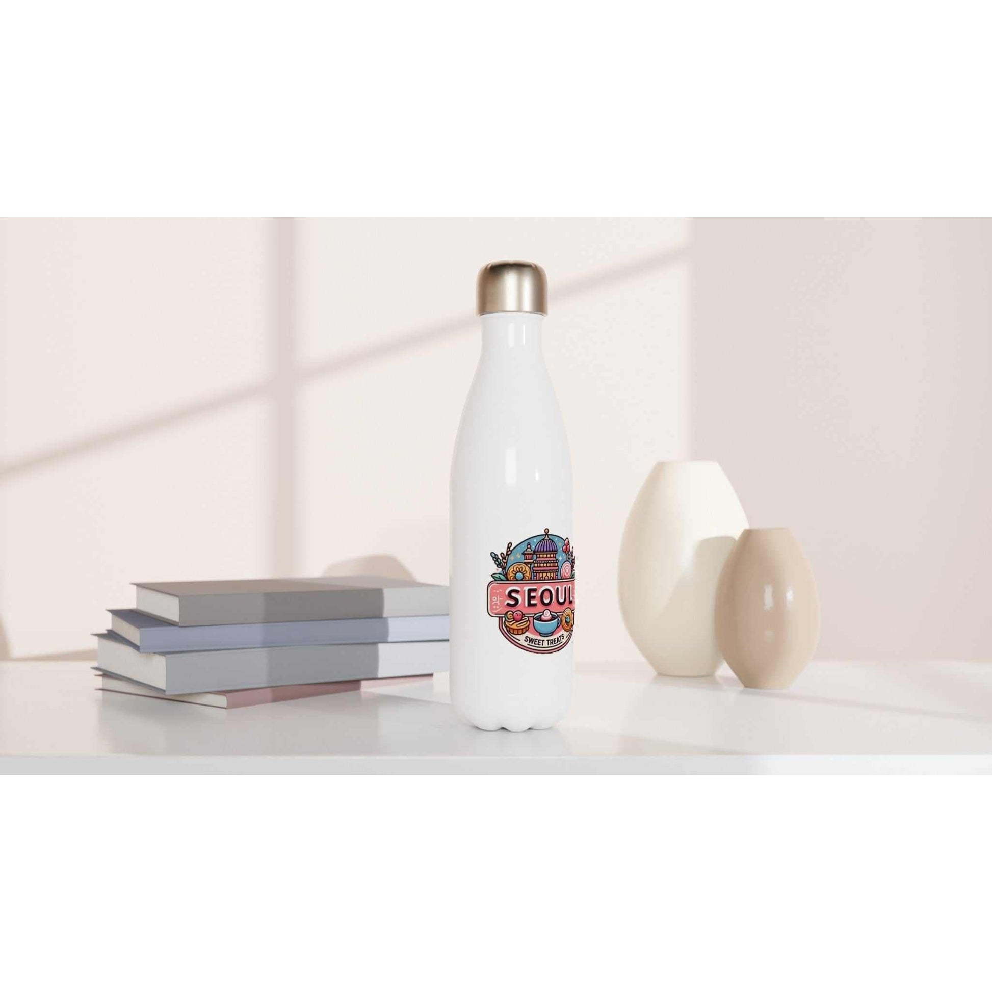 Seoul Sweet Treats Bakery Stainless Steel Water Bottle on a table with a sleek design and colorful logo.